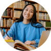 Student reading in library and smiling