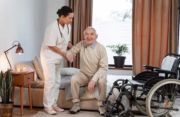 Health personnel helping old man